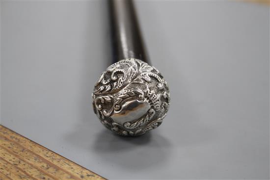 A Victorian walking stick with embossed silver pommel H.M., Birmingham 1906, opens to reveal a compass, overall length 89.5cm